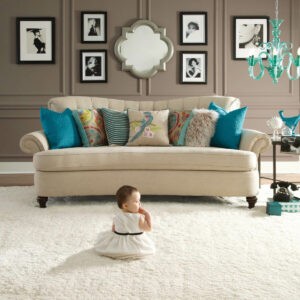 Cute baby sitting on bright carpet | Rugworks | Sonoma and Rohnert Park, CA