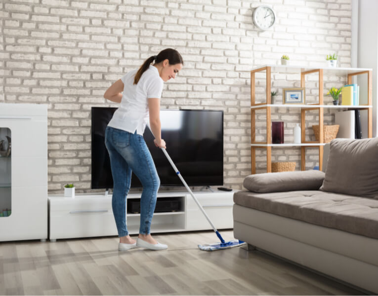 person sweeping hardwood flooring | Rugworks | Sonoma and Rohnert Park, CA