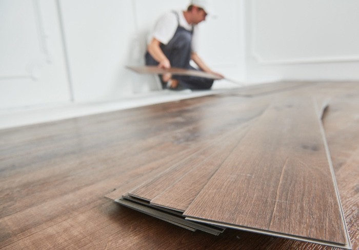 Person installing luxury vinyl flooring | Rugworks | Sonoma and Rohnert Park, CA