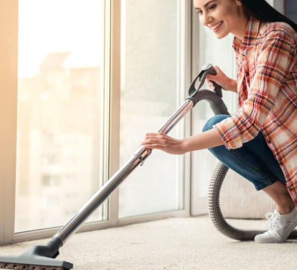 Woman cleaning carpet floor | Rugworks